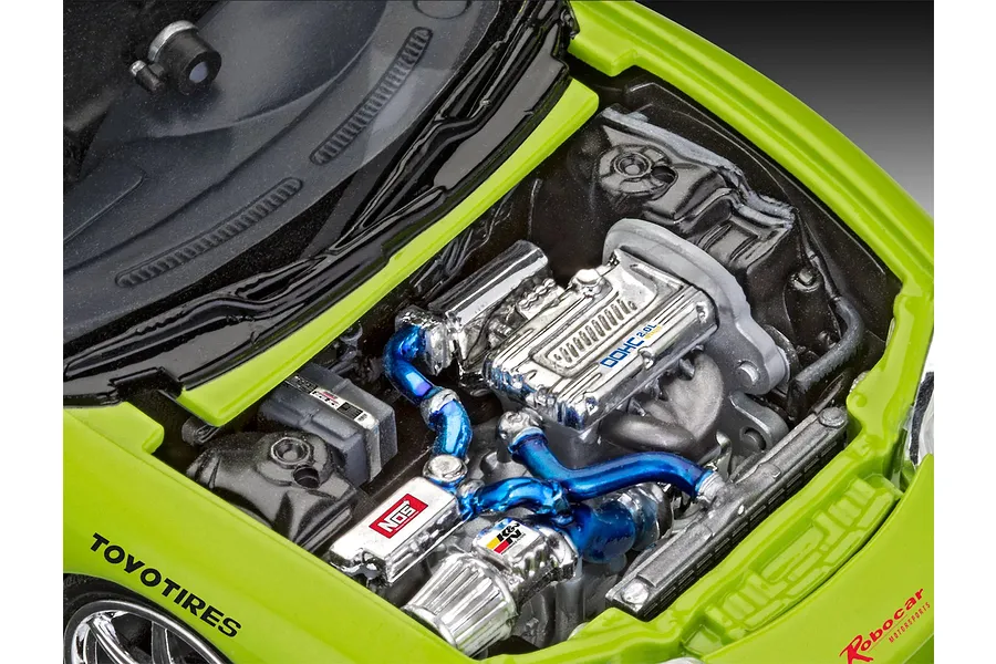 Close-up of the detailed engine bay of a lime green 1/25 scale model Mitsubishi Eclipse, featuring chrome engine parts and blue intake piping.