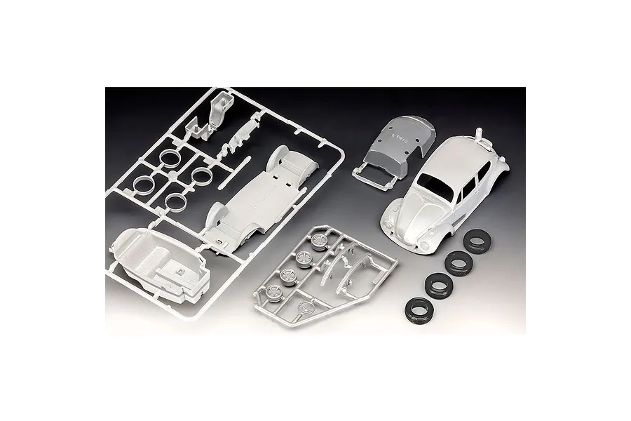 Unassembled plastic model kit parts for a 1/32 scale VW Beetle, including sprues, car body, and rubber tires on a gradient background.