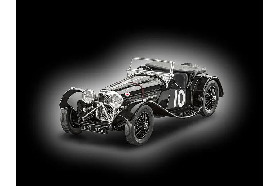 A studio shot of a finished 1/32 scale black Jaguar SS 100 model car with number 10 on the side and a British flag decal on the hood.