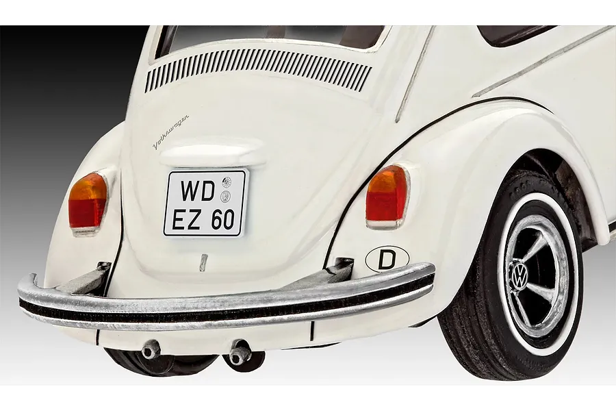 Close-up rear view of a white Revell 1/32 scale Volkswagen Beetle plastic model car, showing the bumper, taillights, and German license plate.