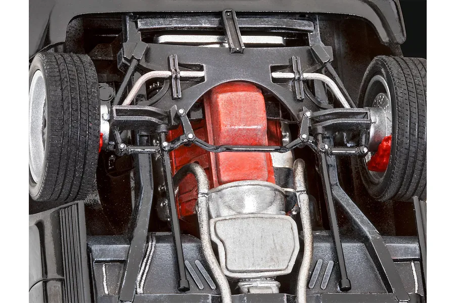 Underside view of a 1/24 scale model car showing the engine, transmission, and front suspension details.