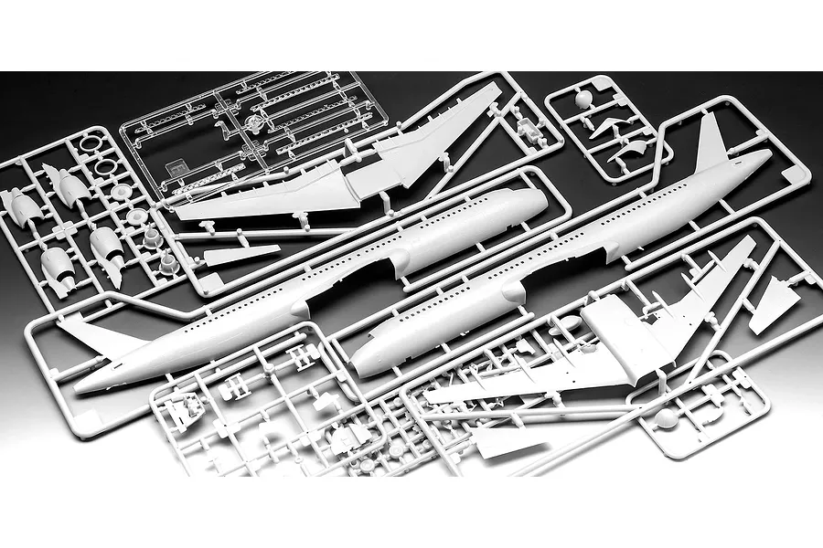 Plastic model kit sprues for an Airbus A321-200 aircraft, showing fuselage halves, wings, and engine parts on a dark background.