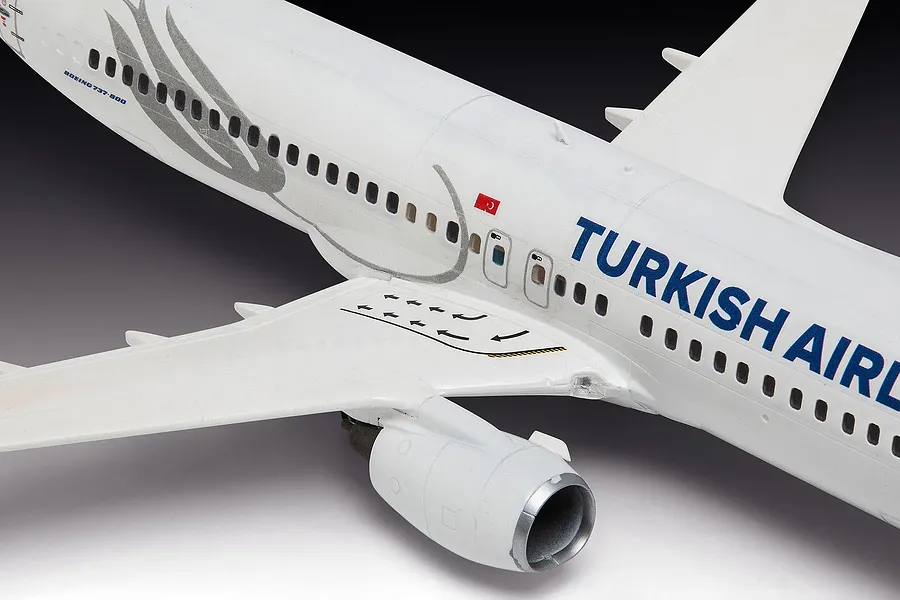 A close-up view of a 1/144 scale Revell Boeing 737-800 model aircraft in Turkish Airlines livery, showing the fuselage, wing, and engine detail.
