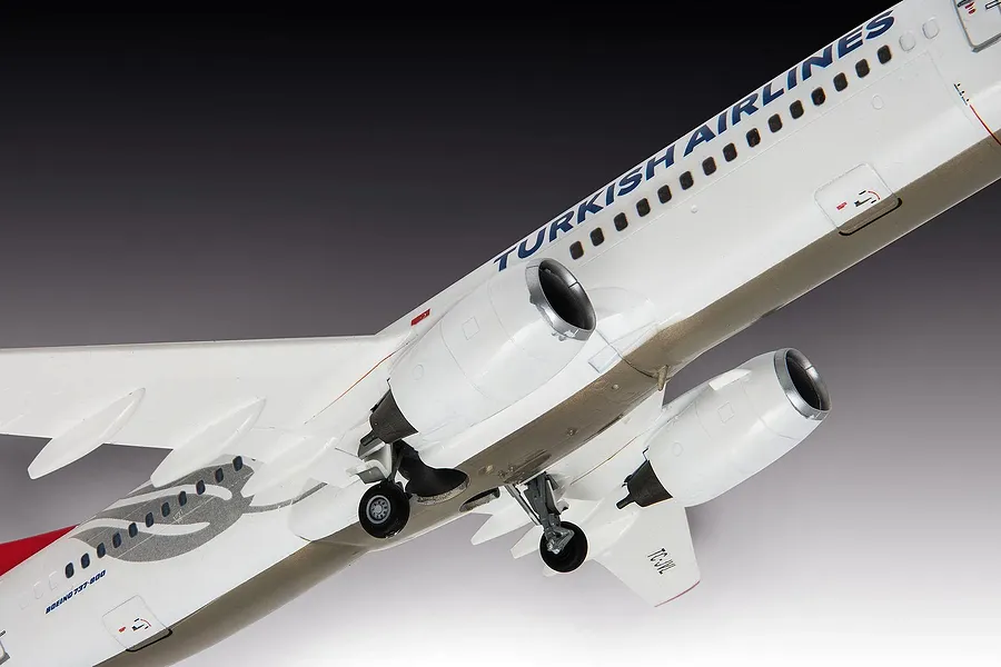 A detailed scale model of a Turkish Airlines Boeing 737-800 aircraft viewed from below, showing the fuselage, wings, engines, and landing gear.