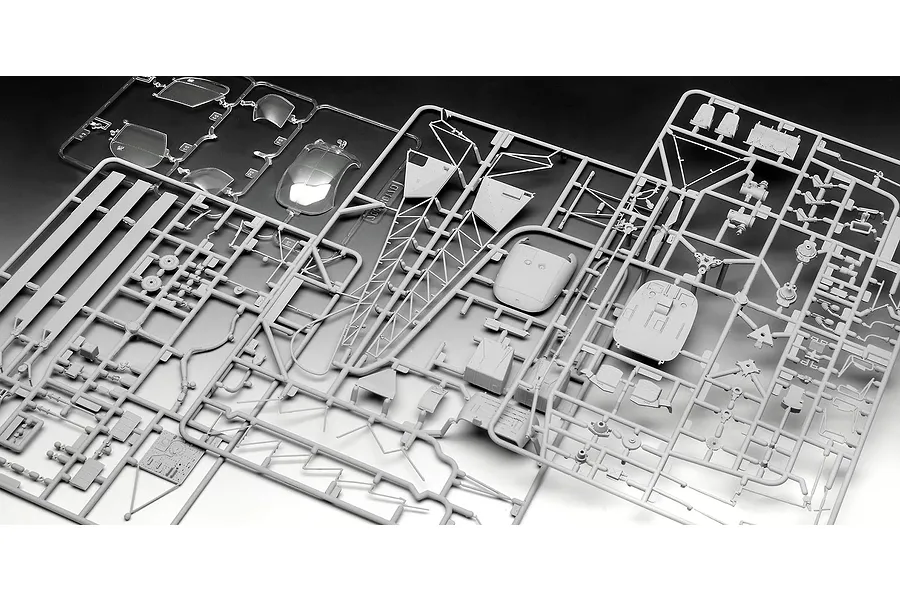 Grey plastic model kit sprues for a Revell 1/32 Alouette II helicopter, including clear canopy parts and various airframe components.