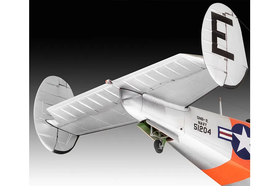 Close-up of the tail section of a 1/48 scale Beechcraft Model 18 model aircraft, showing silver fuselage, orange markings, and US Navy insignia.
