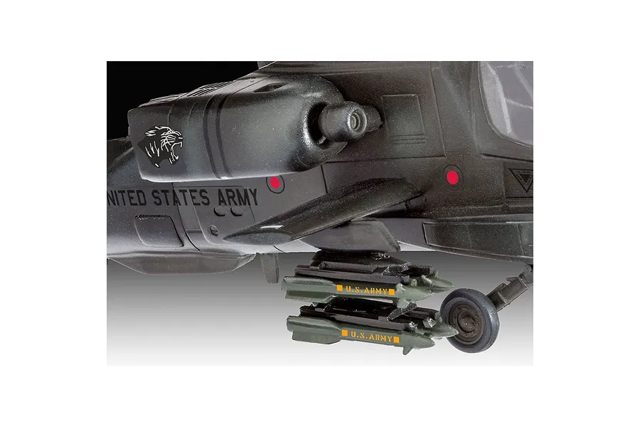 Close-up of a 1/100 scale Revell AH-64A Apache model helicopter showing the fuselage, side-mounted missiles, and landing gear.