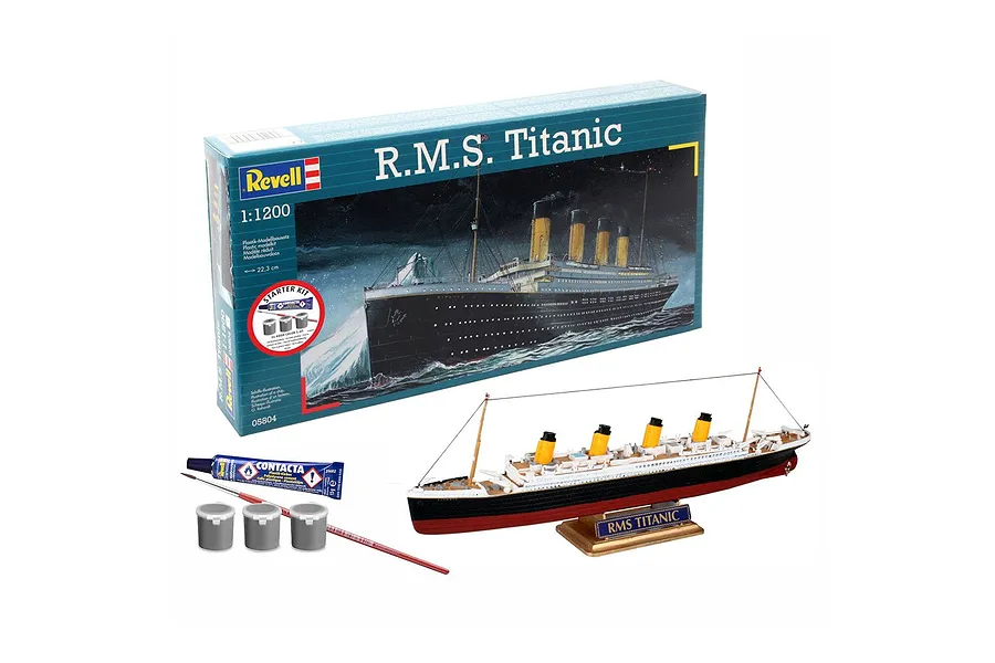 Revell 1/1200 scale R.M.S. Titanic plastic model starter kit, including the box, assembled ship model, glue, paints, and a paintbrush.