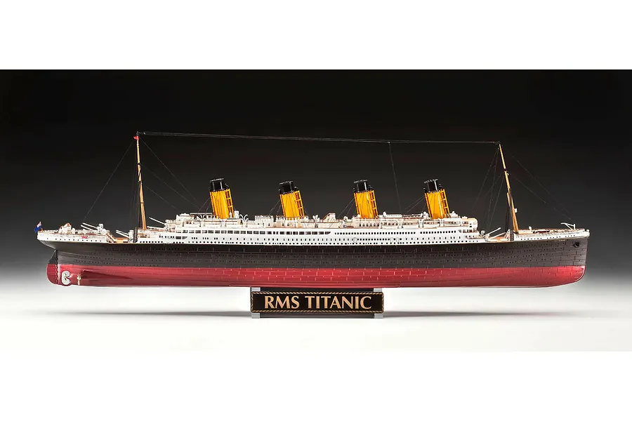 A side-profile studio shot of a fully assembled Revell 1/400 scale RMS Titanic model ship, mounted on a black display stand with the nameplate RMS TITANIC.