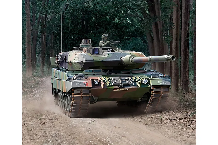 Box art illustration of a Leopard 2 A6 tank in a forest setting, featuring camouflage paint and a crew member in the turret.