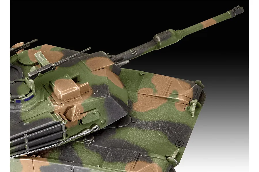 Close-up of a painted 1/72 scale M1 Abrams tank model showing the turret, main gun, and camouflage pattern.
