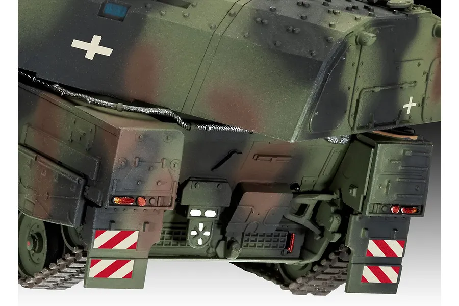 Close-up of the rear section of a 1/72 scale Panzerhaubitze 2000 model tank, showing camouflage paint, red and white hazard markings, and track details.