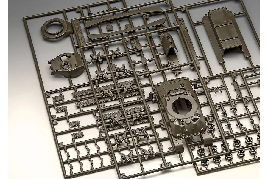 A plastic model kit sprue containing various parts for a 1/72 scale Sherman M4A1 tank, including the hull, turret, and track segments.
