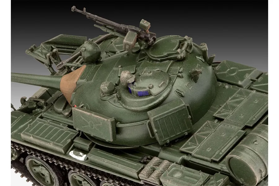 A close-up, high-angle view of an assembled and painted 1/72 scale T-55A tank model, showing the turret, main gun, and machine gun.