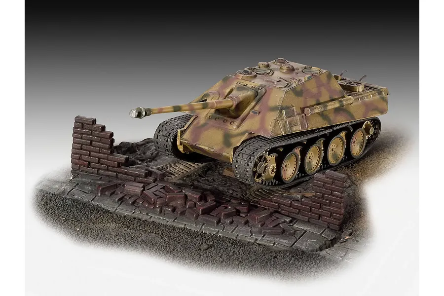 A completed 1/76 scale Revell Jagdpanther model tank displayed on a diorama base with a ruined brick wall.