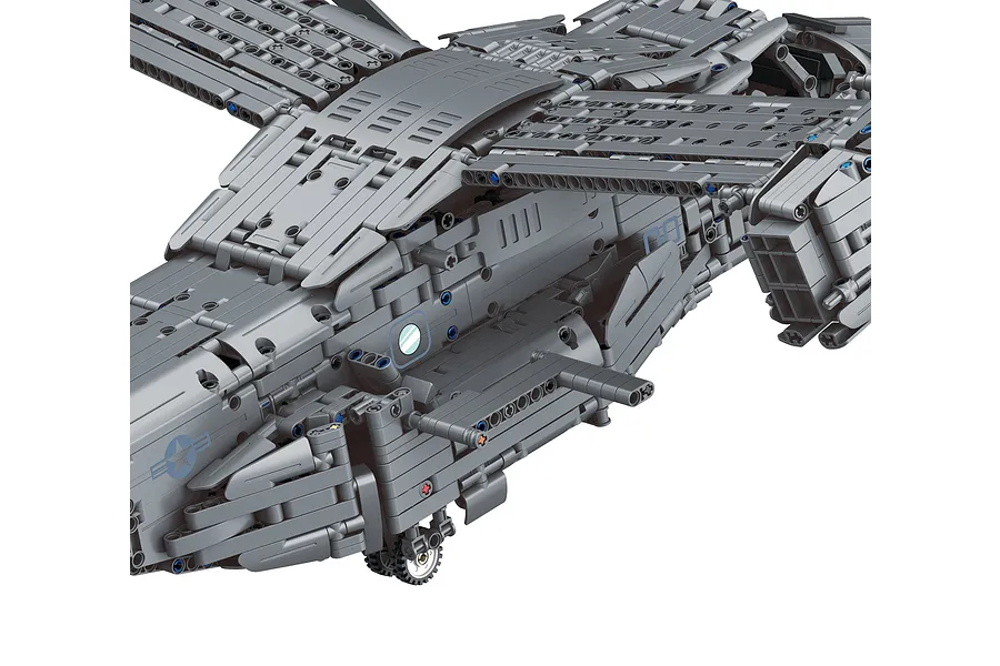 Close-up of a grey brick-built model of a V-22 Osprey aircraft showing the fuselage, wing structure, and landing gear.