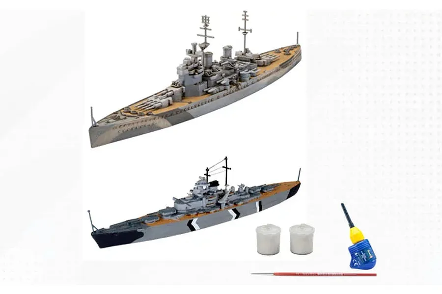 Two assembled and painted plastic model battleships, Bismarck and Prince of Wales, with two small paint pots, glue, and a paintbrush.