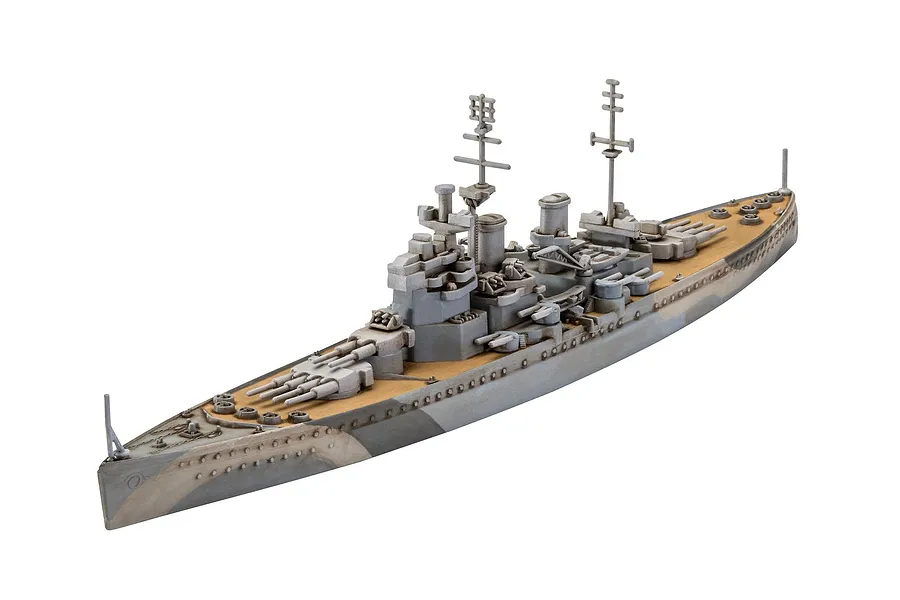 A high-angle studio shot of a 1/1200 scale plastic model of the battleship Bismarck, featuring grey hull camouflage and a tan deck.