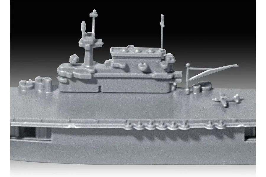 Close-up of the grey plastic island structure and flight deck of a 1/1200 scale USS Enterprise CV-6 model kit.