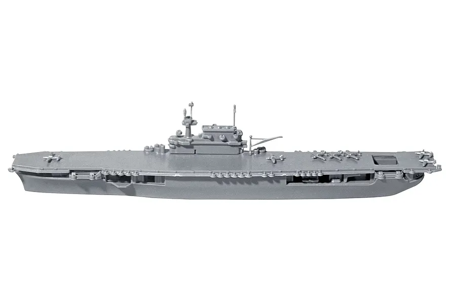 A side-profile view of an unpainted grey plastic model of the USS Enterprise CV-6 aircraft carrier, showing the flight deck and island structure.
