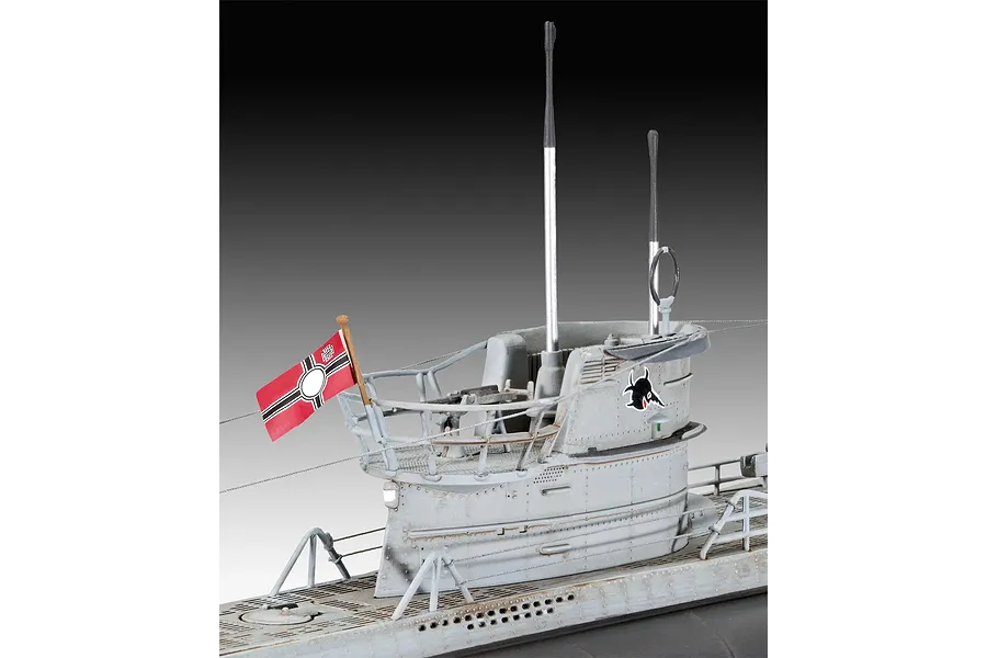 A close-up view of the conning tower of a 1/144 scale Revell U96 submarine model, showing the grey hull, periscopes, railing, and a small flag.