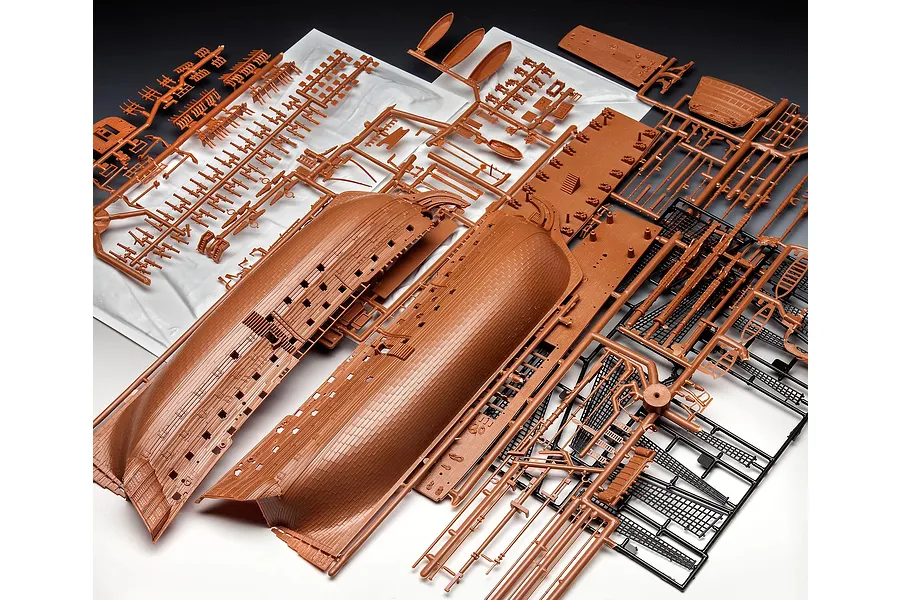 Plastic model kit sprues for the Revell 1/225 HMS Victory, showing brown hull halves and various black and brown ship components.