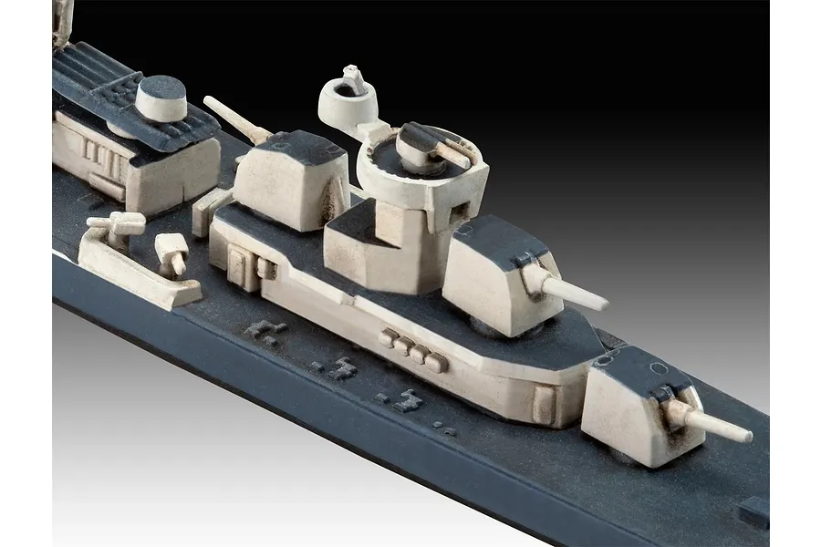 Close-up of a 1/700 scale plastic model warship deck showing gun turrets and superstructure details.