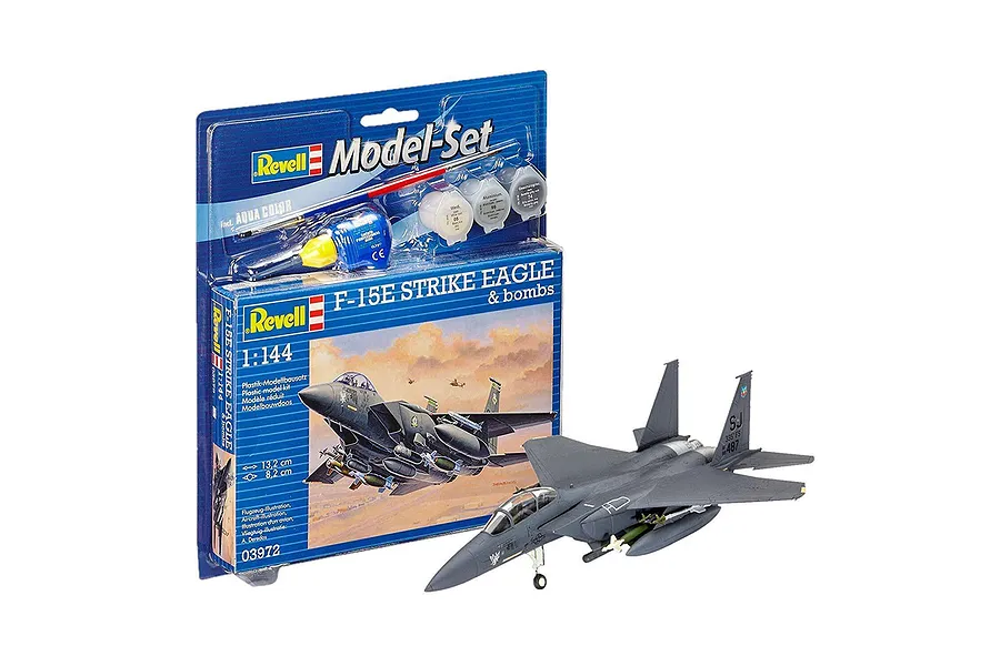 Revell 1/144 scale F-15E Strike Eagle plastic model kit in blister packaging with a fully assembled and painted model aircraft displayed in front.