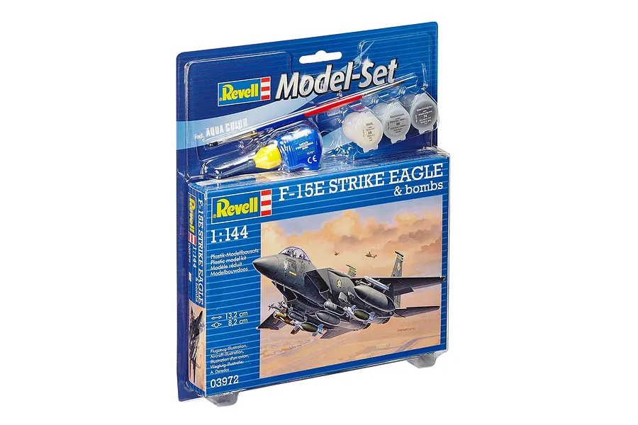 Revell 1/144 scale F-15E Strike Eagle model kit in blister packaging with included paint pots and glue.