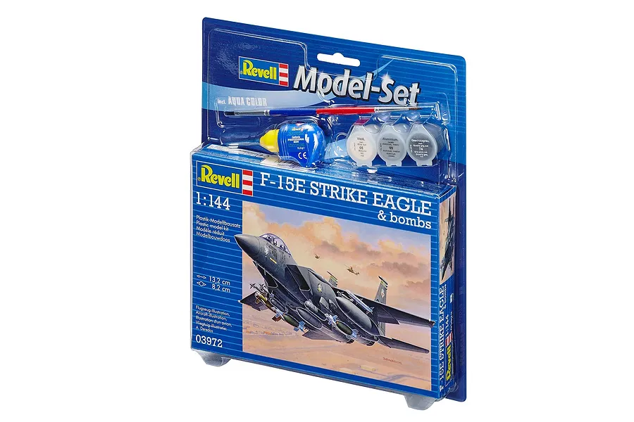 Revell 1/144 scale F-15E Strike Eagle model kit in blister packaging with included paint, glue, and brush.