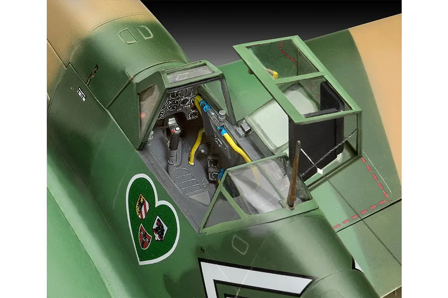 Close-up of the detailed cockpit area of a 1/32 scale Messerschmitt Bf 109 model aircraft, showing the open canopy and painted interior.