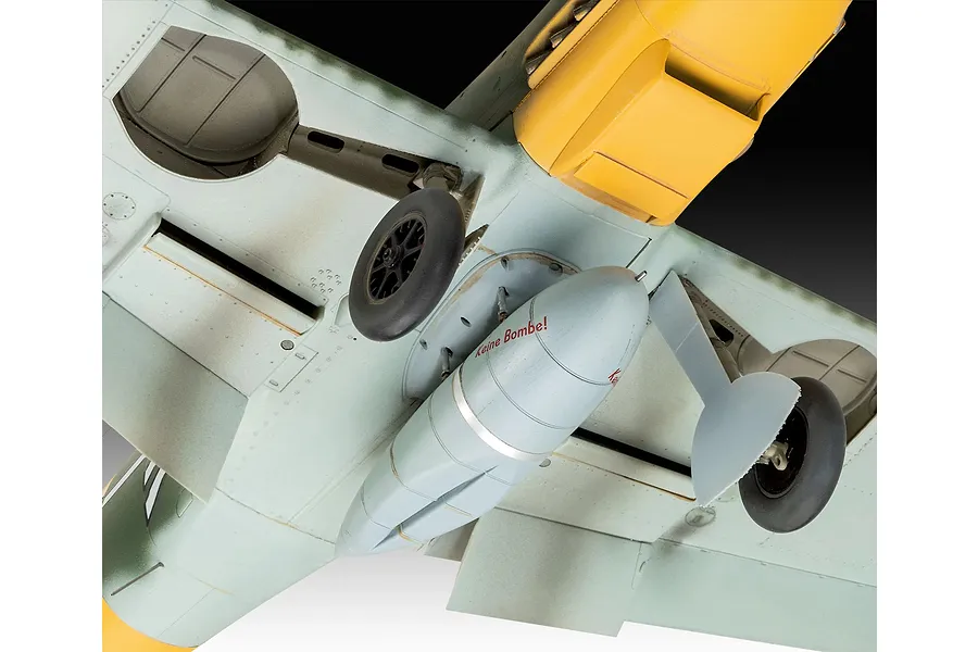 Underside view of a scale model Messerschmitt Bf 109 showing the landing gear and a drop tank with the text Keine Bombe!