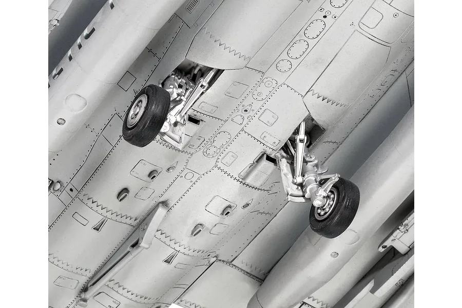 Close-up view of the underside of a plastic model Dassault Rafale C aircraft, showing landing gear detail and panel lines.