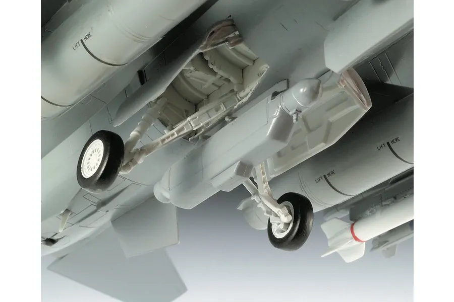Close-up of the landing gear and under-wing fuel tanks of a 1/72 scale plastic model aircraft, showing detailed landing gear struts and wheels.