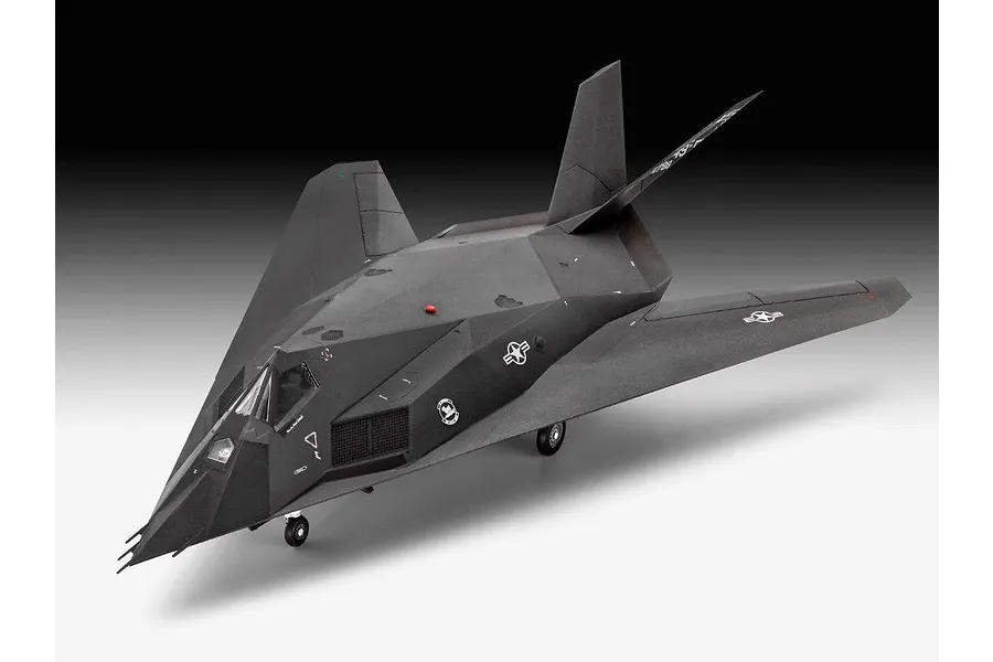 A completed plastic model of an F-117 Nighthawk stealth aircraft, shown from a high-angle front three-quarter view against a gradient background.