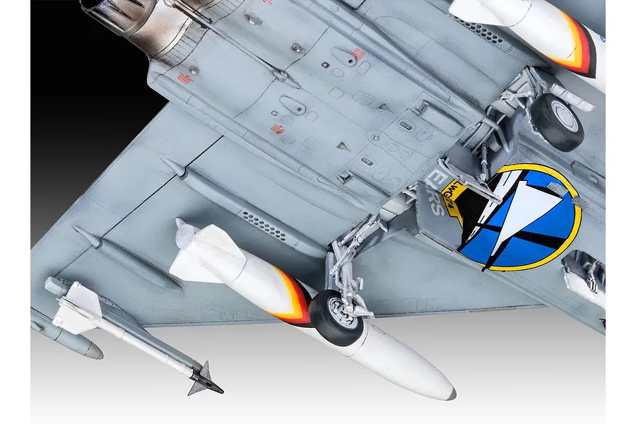 Close-up view of the underside of a 1/72 scale Eurofighter Typhoon model kit, showing landing gear, missiles, and Bavarian Tiger livery details.