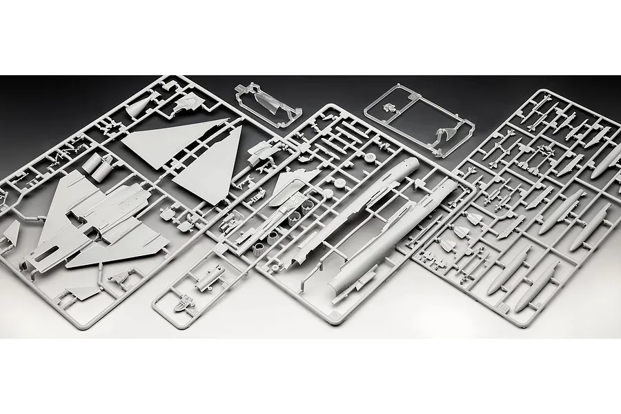 Plastic model kit sprues for a 1/72 scale Eurofighter Typhoon, showing grey aircraft parts and clear canopy pieces on a dark background.