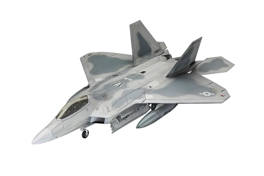 A fully assembled and painted 1/72 scale plastic model of a Lockheed Martin F-22A Raptor fighter jet, shown from a high-angle front three-quarter view.