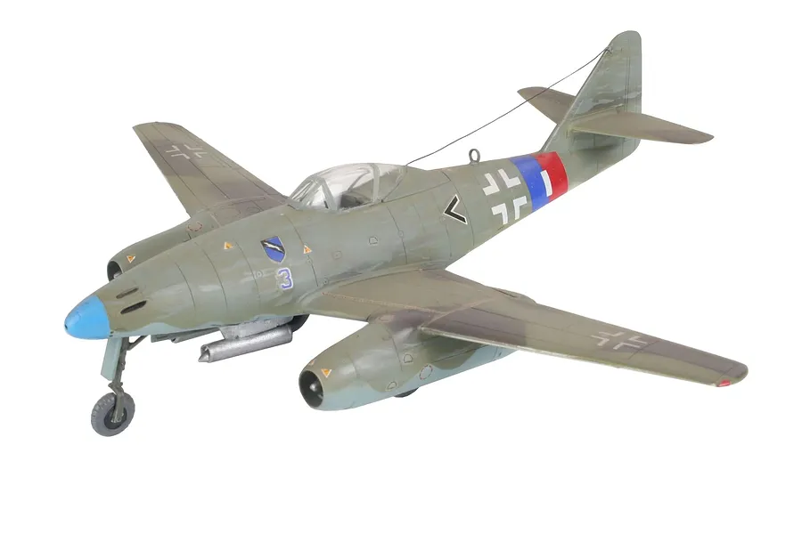 A fully assembled and painted 1/72 scale model of a Messerschmitt Me 262 jet fighter, featuring camouflage paint and German Luftwaffe markings.