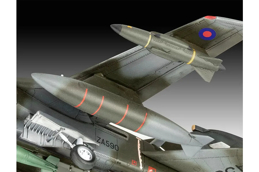 Close-up of a 1/72 scale Panavia Tornado plastic model aircraft showing the underside, landing gear, and external fuel tanks against a gradient background.