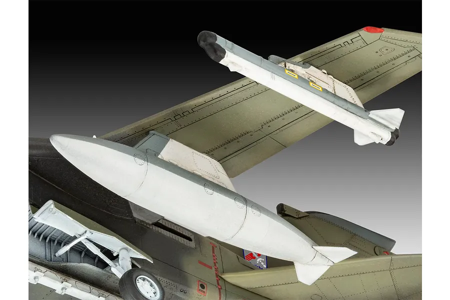 Close-up of a 1/72 scale plastic model Panavia Tornado aircraft showing the underside, landing gear, and external fuel tank.