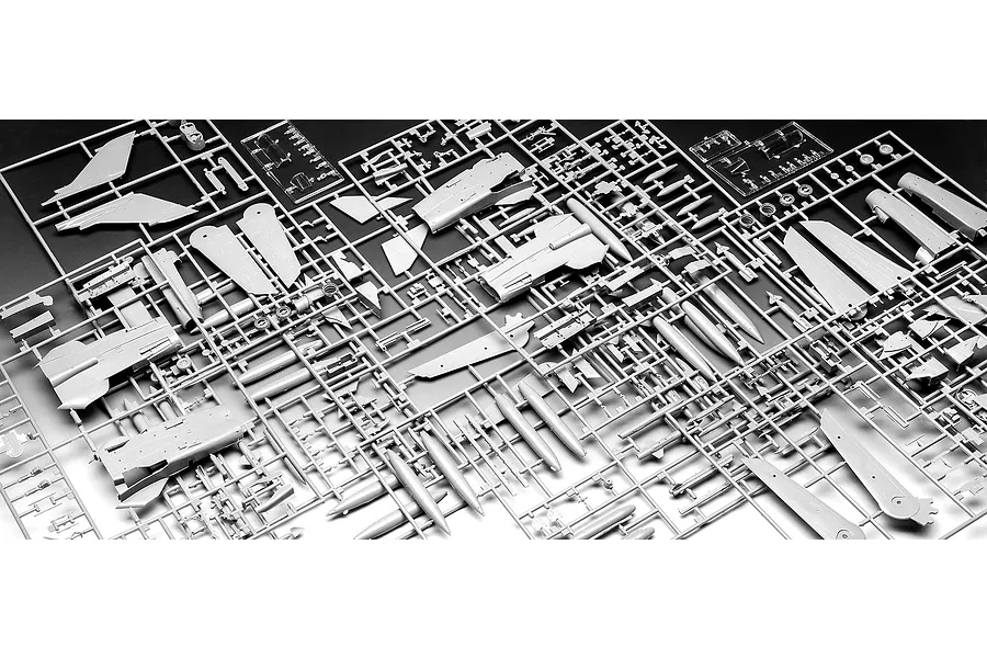 A high-angle view of multiple grey plastic model kit sprues for a Panavia Tornado aircraft, showing various fuselage, wing, and weapon parts.