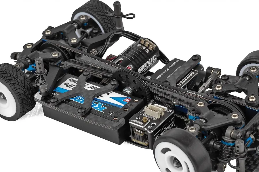 Close-up of the chassis of a Team Associated 1/28 scale RC car, showing the motor, battery, servo, and drivetrain components.