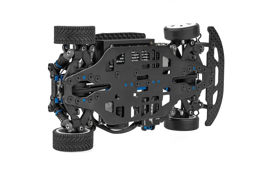 Bottom view of a Team Associated TC28 1/28 scale RC car chassis showing the black carbon fiber main deck, suspension components, and rubber tires.