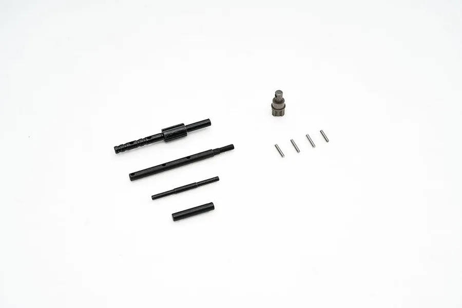 A set of FMS transmission gear shift components including metal shafts, pins, and a small gear part on a white background.