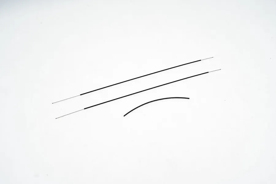 A set of three thin steel wires with black protective sleeves, laid out on a plain white background.