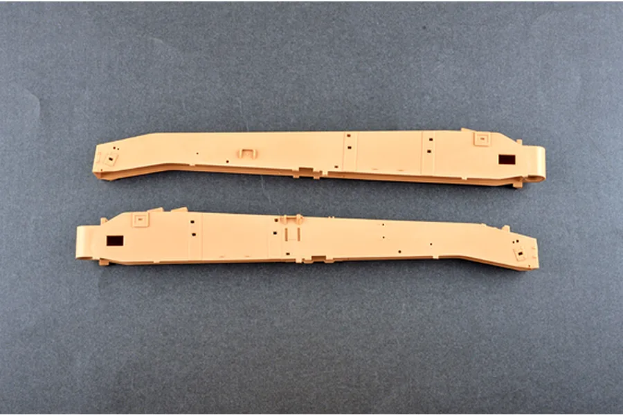 Two tan plastic model kit parts for the I Love Kit 1/16 M198 155mm Towed Howitzer, laid flat on a grey background.