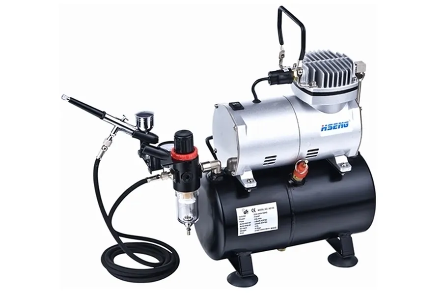 Hseng air compressor unit with a black air tank, silver motor, pressure regulator, and an attached airbrush with a black hose.