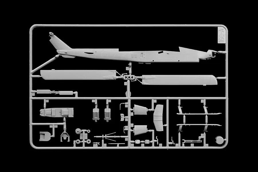 A grey plastic sprue containing various parts for an Italeri 1/72 AH-1W Super Cobra model kit, including the helicopter fuselage and rotor blades.