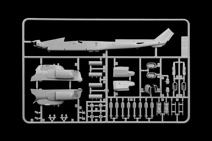 A grey plastic sprue from an Italeri 1/72 scale AH-1W Super Cobra model kit, featuring helicopter fuselage halves and various weapon components.